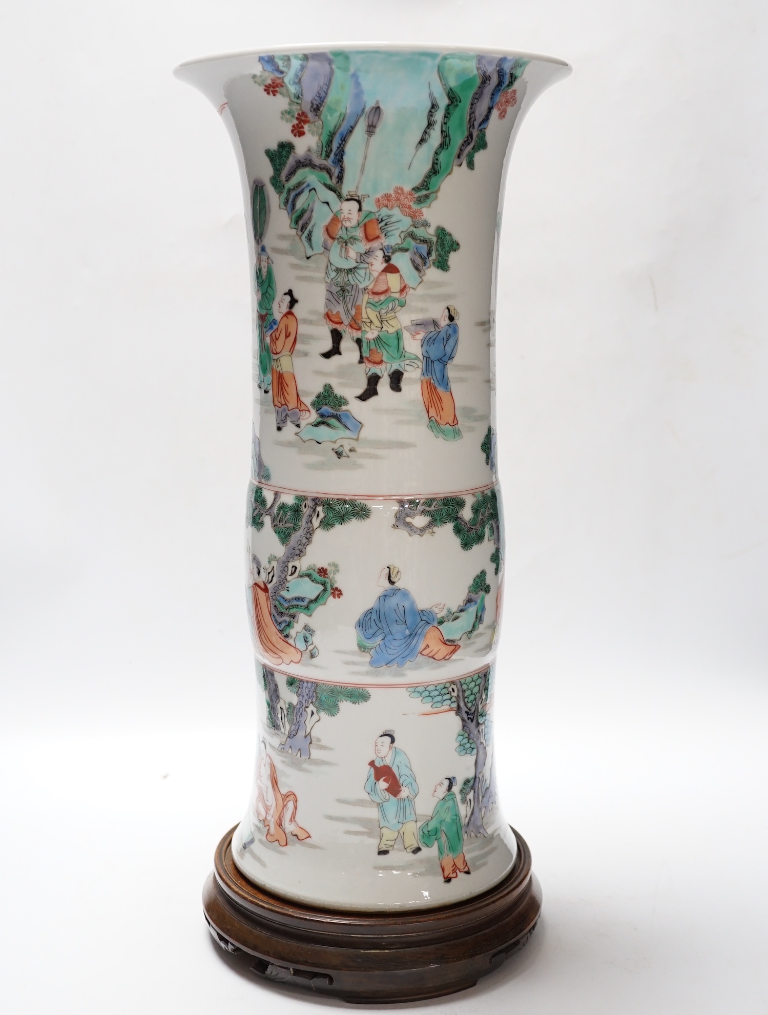 A Chinese famille verte beaker vase, Kangxi mark but later, on hardwood stand, 46cm total height